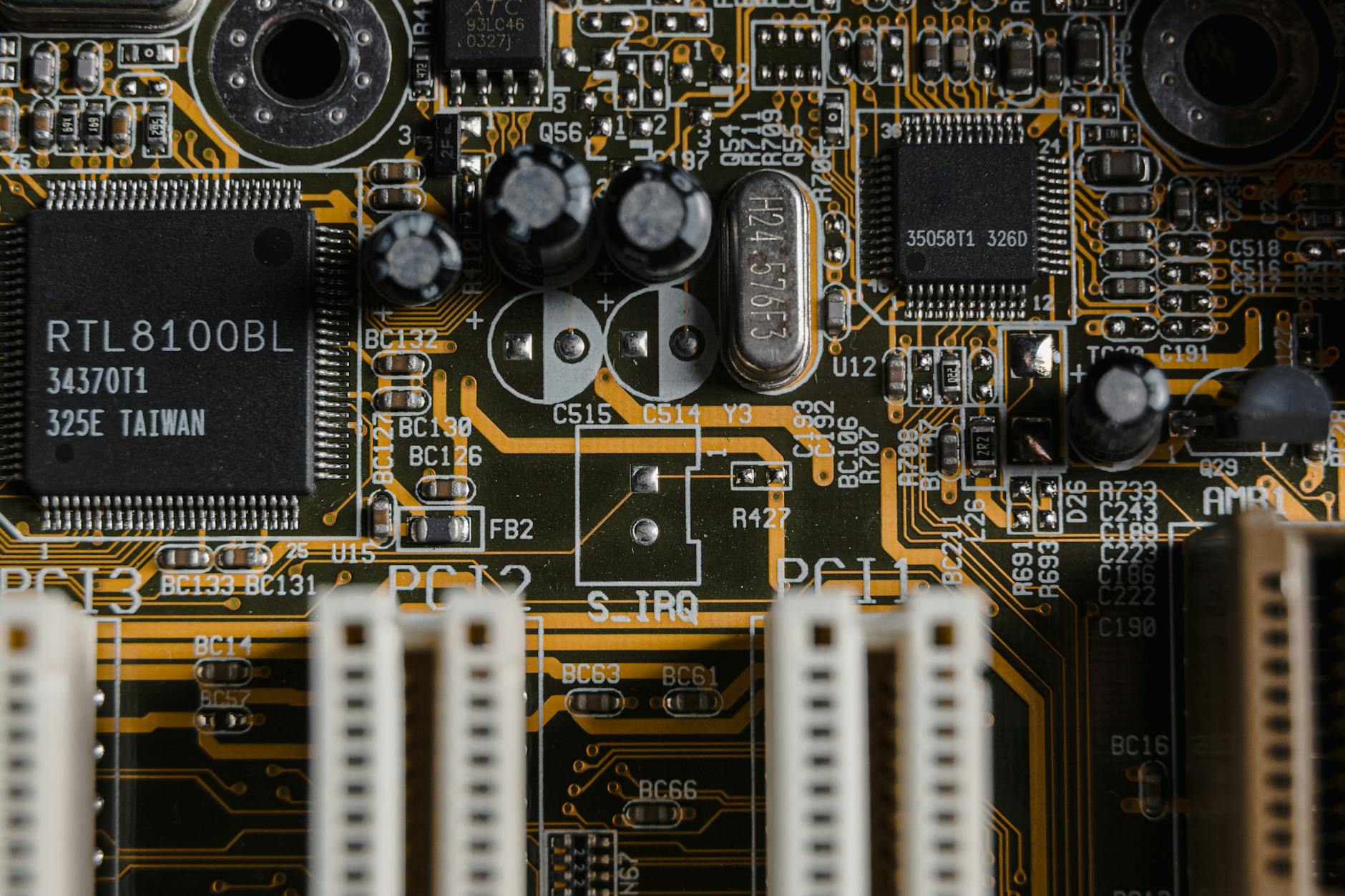 gold motherboard in close up photography