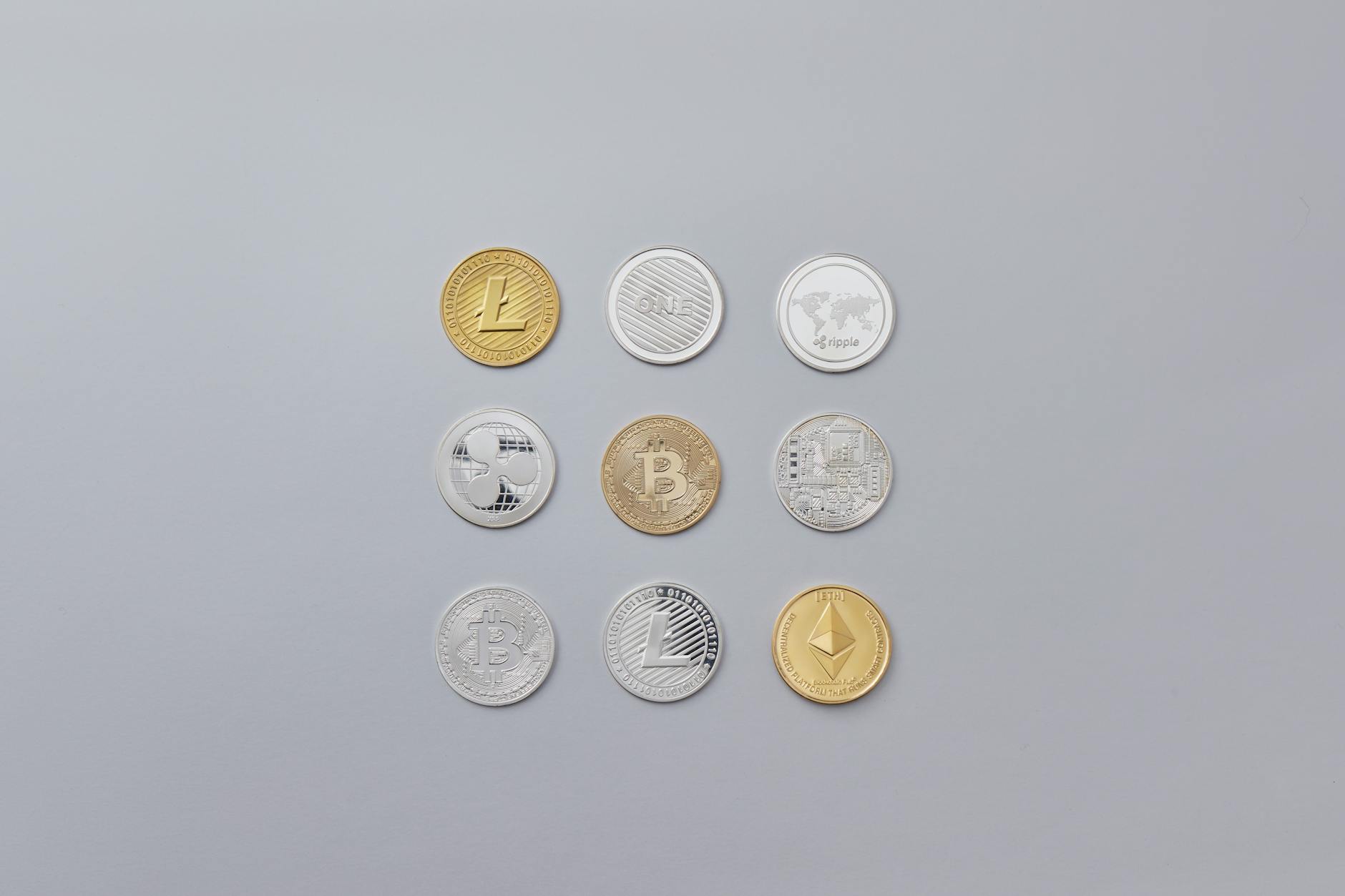 silver and gold round coins on grey background